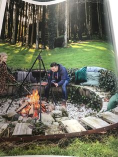 an open magazine with people sitting around a campfire