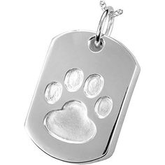 a dog's paw print on a silver tag