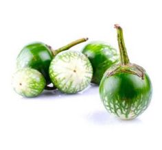 some green fruits are on a white surface