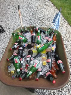 a tray full of beer bottles sitting on the ground