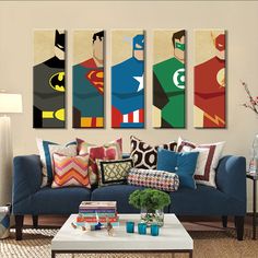 a living room filled with blue couches covered in pillows and batman artwork on the wall