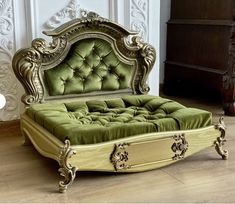 a green bed sitting on top of a hard wood floor next to a white wall