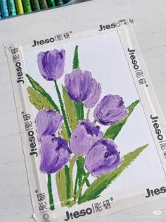 some purple flowers are on a piece of paper