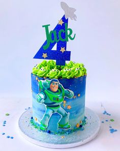 a blue and green cake with the number four on it