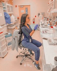 a woman sitting on a chair in a lab