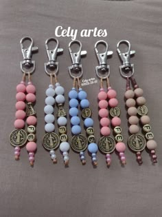 several key chains with beads and charms on them