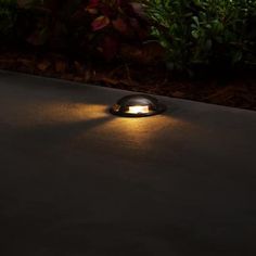 an outdoor light shines brightly on the ground