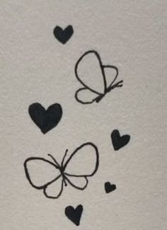 some black hearts and a butterfly on a white paper with the words love written in it