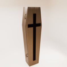 a wooden box with a black cross on the front and sides, against a white background