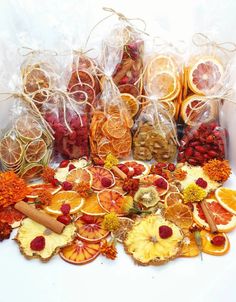 many different types of fruit are arranged on the table with some cinnamons and oranges