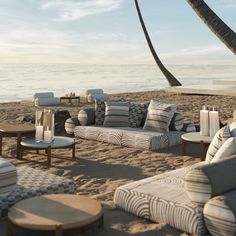 an outdoor seating area on the beach with palm trees in the background