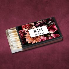 matches are in a box with flowers on the front and bottom, along with white matchesticks