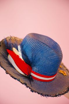 Sail into the summer with our BON VOYAGE SUN HAT! This stylish blue and gold hat features a bold red and white striped ribbon band and a playful gold sailboat pin. Finished with a patriotic red, white, and blue feather combo, it's perfect for any beach day or boat trip. This hat is ONE OF A KIND, created by our owner Stephanie. To receive item quicker, expedited shipping is available at checkout. Red Beach Hat For 4th Of July, Red Hat For Beach And 4th Of July, Patriotic Beach Hats For Spring, Patriotic Beach Hat For Spring, Patriotic Hats For Beach In Spring, Patriotic Blue Beach Hat, 4th Of July Beach Hat With Wide Brim, Blue Curved Brim Hat For 4th Of July, 4th Of July Wide Brim Beach Hat