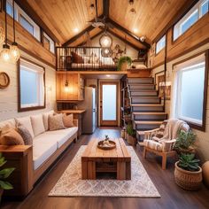 a living room filled with furniture and lots of wood flooring next to a stair case