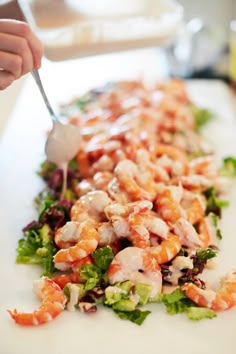 a person is cutting up some food on a white plate with a fork in it