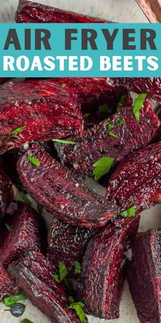 roasted beets on a white plate with mint garnish and text overlay that reads air fryer roasted beets