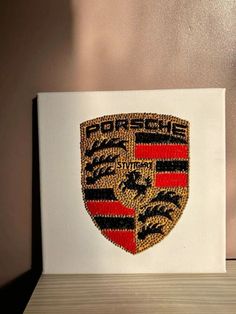 a white canvas with a red and black emblem on it sitting on a wooden table