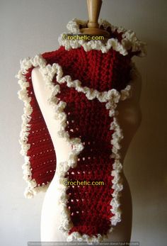 a crocheted red and white scarf on a mannequin