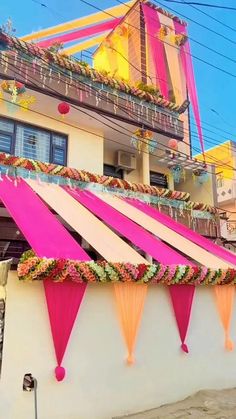 a building with pink and yellow decorations on it