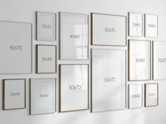 there are many frames on the wall with numbers and words in each one, all hanging up