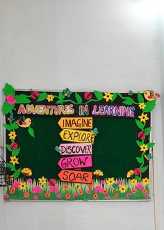 there is a sign on the wall that says adventures in learning and imagine explore grow soar