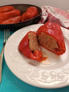 a white plate topped with meat covered in sauce