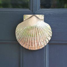 a close up of a door with a shell on the front and side paneling