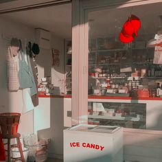 an ice candy shop with red balloons hanging from the ceiling and other items on display