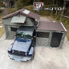 an suv parked in a parking lot next to a tent and awnings on top of it