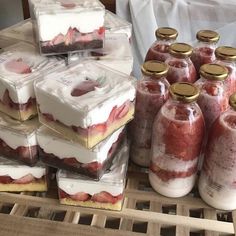 there are many desserts in glass containers on the table