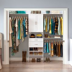 an organized closet with clothes, shoes and other items hanging on the wall next to it