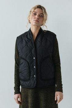 The Anouk Vest is pure comfort and warmth. This quilted vest features a snap front closure and roomy front pockets. The textile is lined with warm and cozy sherpa fleece. Cut roomy for all kinds of layering possibilities. Oversized fit. Model is wearing X SMALL. Model is 5'8". Please review our size guide prior to ordering. Need specific measurements? Send us an email and we will be happy to help you find the perfect fit. Hooded Vest Outfit, Quilted Vest, Sherpa Fleece, Pull On Pants, Black Media, Oversized Fits, Warm And Cozy, Size Guide, Full Length