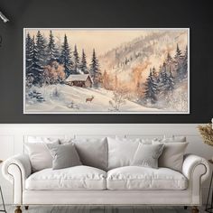 a living room with a white couch and painting on the wall