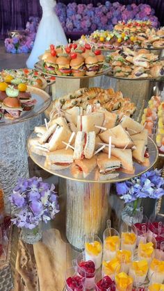 a table topped with lots of different types of sandwiches and cupcakes next to each other