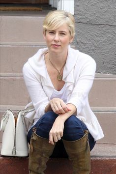 a woman sitting on steps with her legs crossed