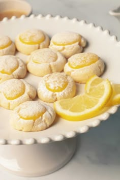 lemon cookies are arranged on a white platter