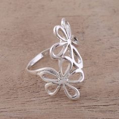 Exciting twin flowers are crafted in sterling silver, decorating the front of this cocktail ring with shining openwork. Designed by Neetu Barathi, this gorgeous accessory glistens wherever it goes. Elegant Sterling Silver Spring Jewelry, Elegant Sterling Silver Jewelry For Spring, Elegant Flower Ring Stamped 925, Elegant Silver Spring Jewelry, Elegant Silver Jewelry For Spring, Sterling Silver Wedding Rings For Spring, Spring Wedding Sterling Silver Flower Ring, Spring Wedding Sterling Silver Jewelry, Silver Jewelry For Formal Spring Occasions