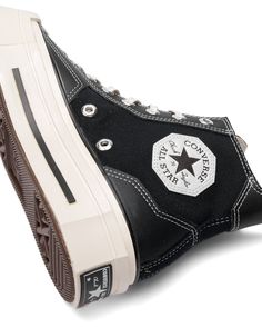 Signature style, reimagined. The Chuck 70 De Luxed Squared takes a geometric approach to unmistakable design details. Angular overlays, eyelets, and patches give your look just enough edge, while heritage styling stays true to your favorite shoes. High-top shoe with a canvas upper and faux leather overlays OrthoLite cushioning helps provide optimal comfort Angular overlays, eyelets, and patches reimagine Chuck Taylor DNA Reimagined rubber midsole details for an unexpected look Squared toe adds b Hip Hop Cargo Pants, Cool Converse, Around The Fur, Converse Logo, High Top Shoe, Dr Shoes, Image Swag