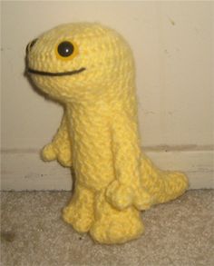 a yellow stuffed animal sitting on the floor