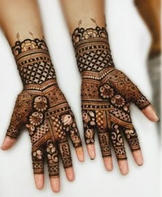 two hands with henna designs on them