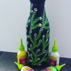 three bottles and one bottle with flowers painted on them