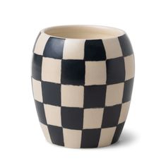 a black and white checkered vase sitting on top of a table