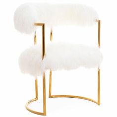 a white chair with gold legs and fur