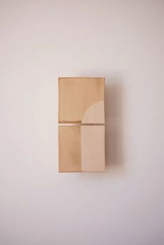 a piece of cardboard sitting on top of a white wall