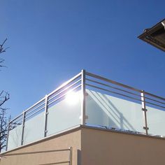 the sun shines brightly through the clear blue sky on top of a building's roof