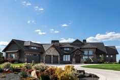 a large house with lots of windows and landscaping