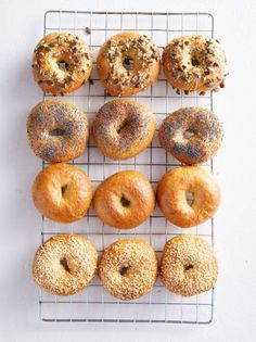 twelve donuts on a cooling rack with sprinkles