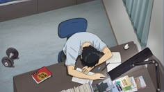 a man sleeping on top of a desk next to a pile of books