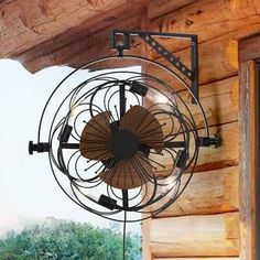 a fan hanging from the side of a wooden building