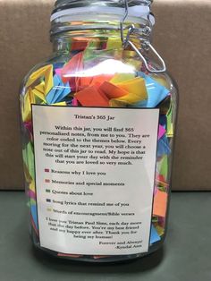 a jar filled with lots of different colored paper